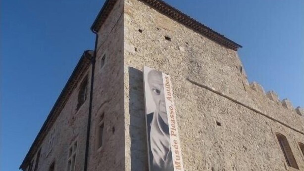 A stone building with a large poster of a woman on the side. - Bright, modern apartment in town center (Antibes)
