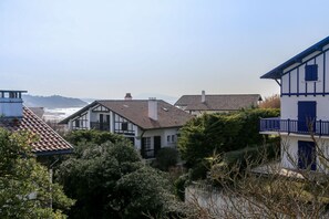 Een kustwoongebied met huizen met traditionele architectuur en uitzicht op zee.