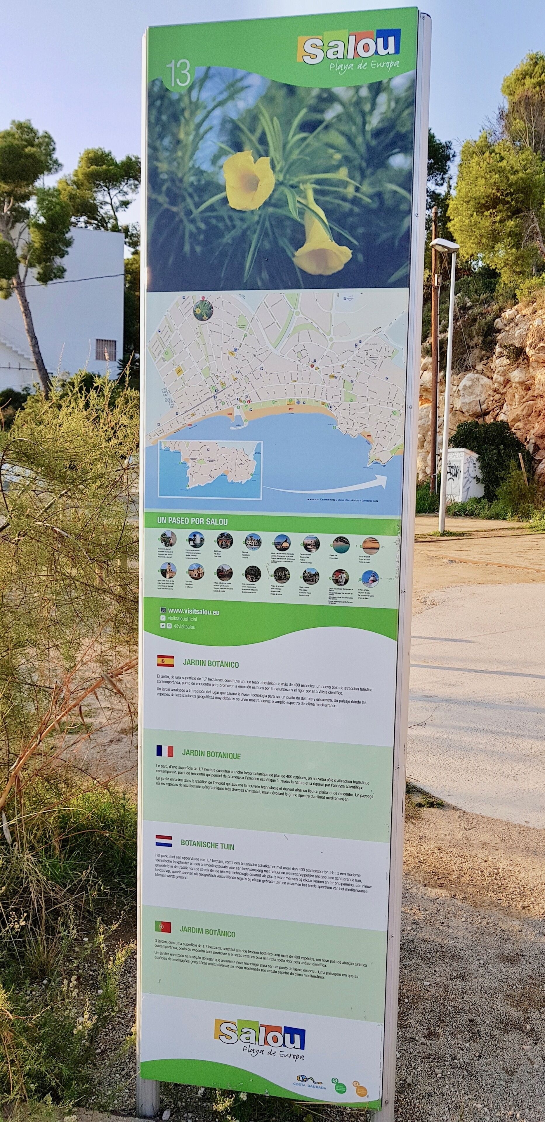 A vertical informational signboard with a map, text, and images of a botanical garden.