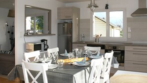 A modern kitchen with white cabinetry, stainless steel appliances, and a dining area set for six with white chairs and a table set with plates, glasses, and cutlery. - HOUSE LOCTUDY Pays Bigouden, 3 bedrooms, Beach 600m, Expo South. Bikes. Wifi (Loctudy)