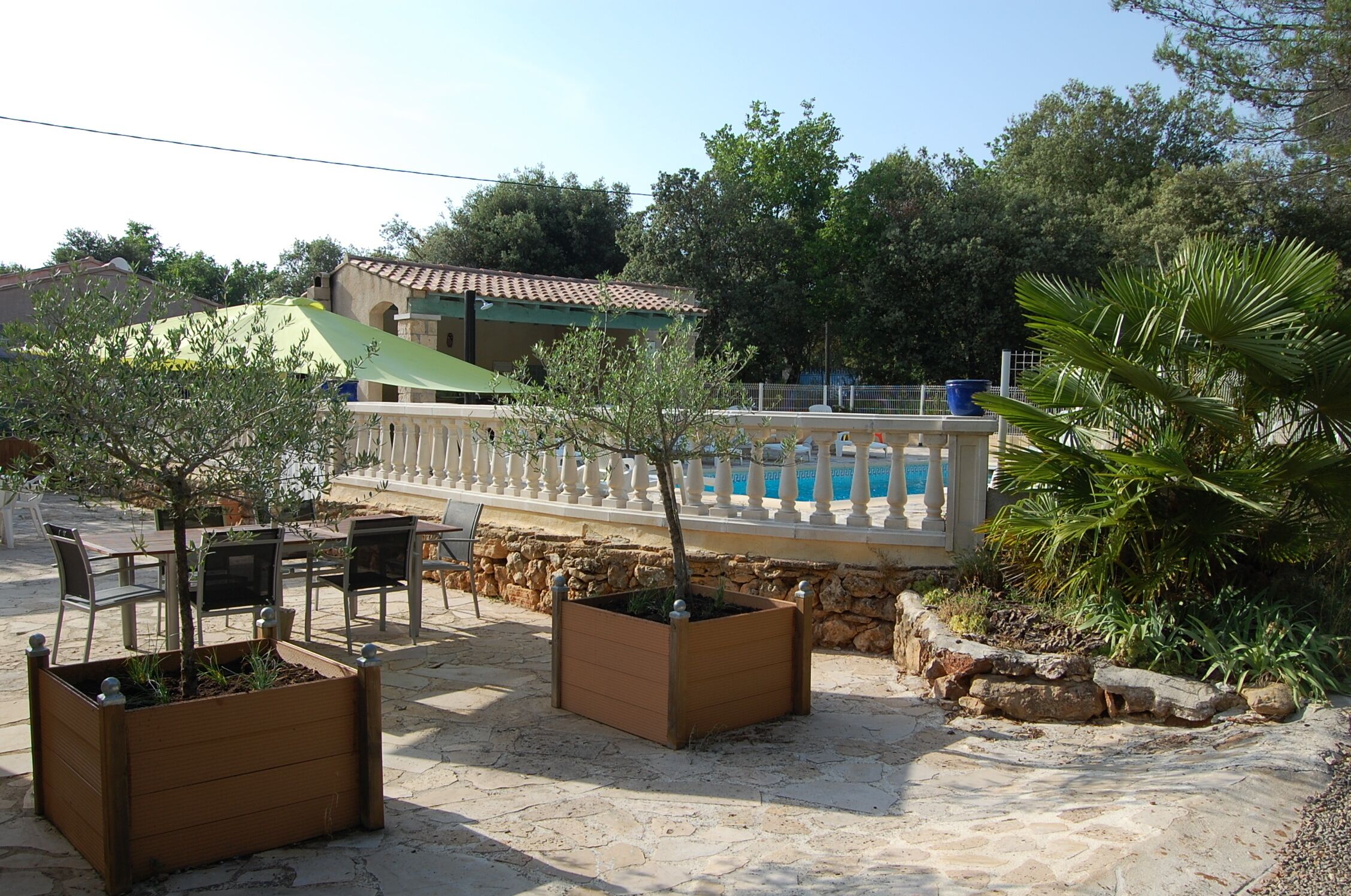 Eine Terrasse mit Gartenmöbeln und Pflanzgefäßen.