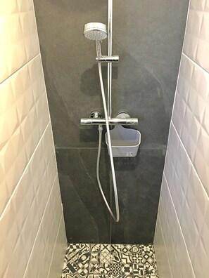 Bathtub, hair dryer, towels, toilet paper