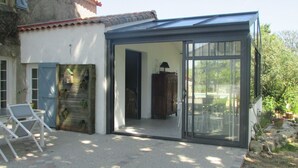 A small, enclosed outdoor space with a sliding glass door leading to a patio area.
