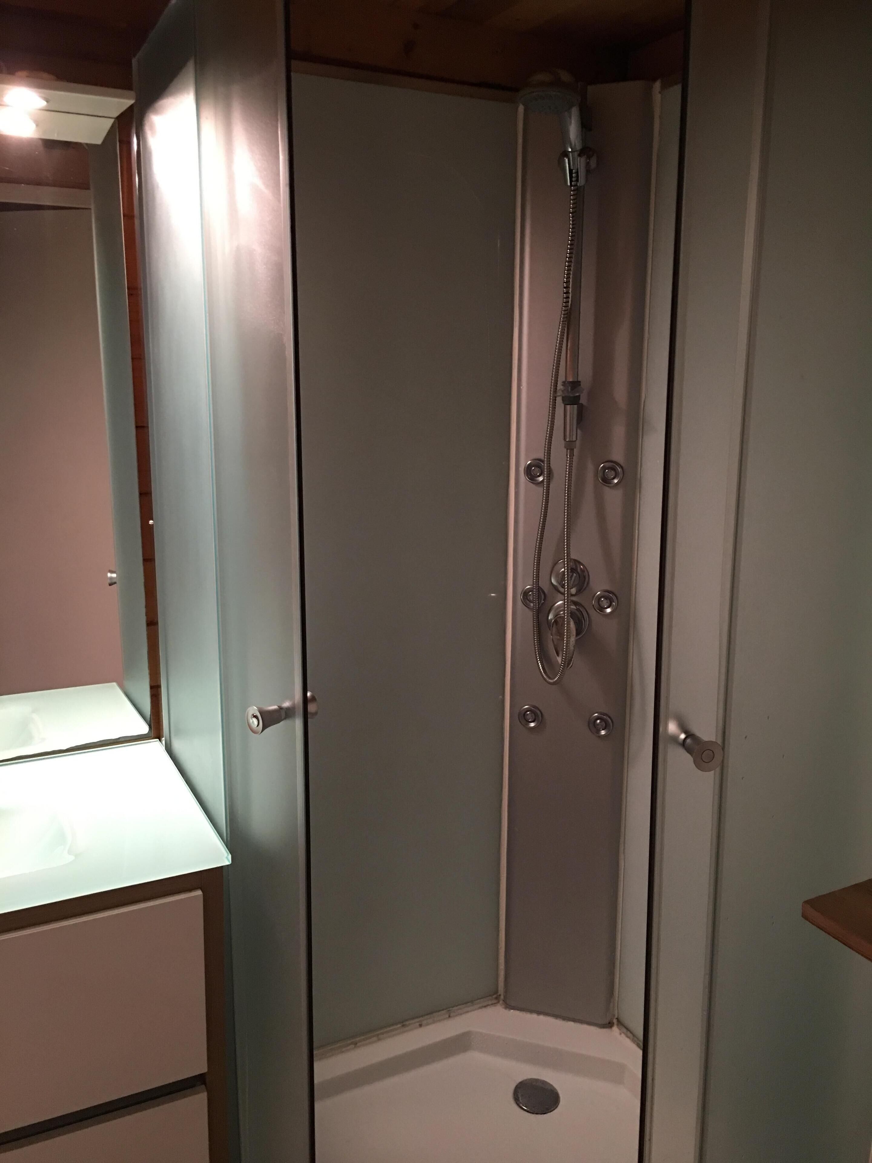 Shower, hair dryer, towels, toilet paper