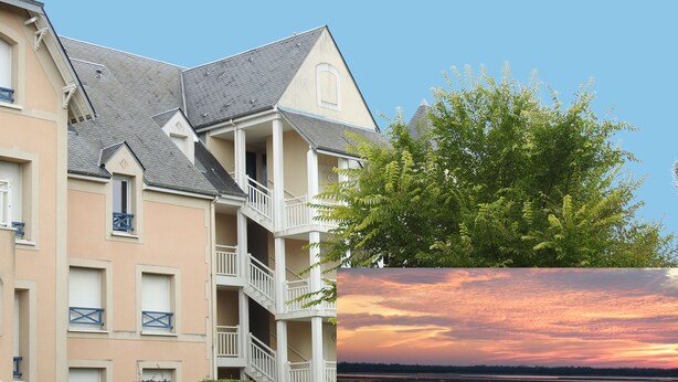A multi-story building with balconies and a clear sky.