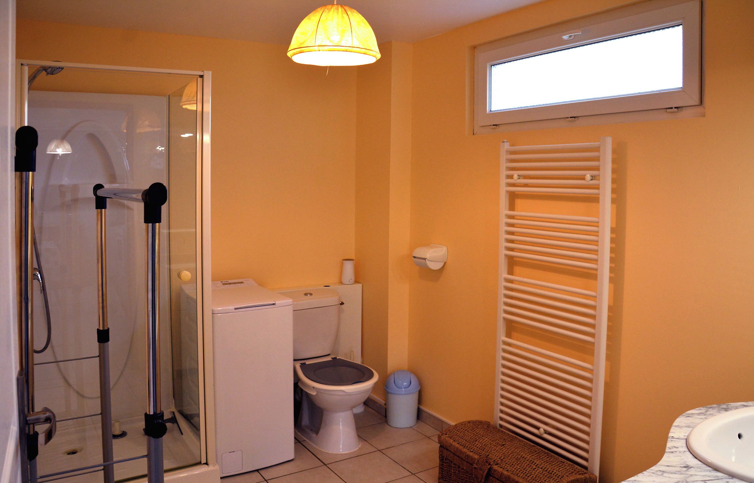 A bathroom with a toilet, bidet, and shower.