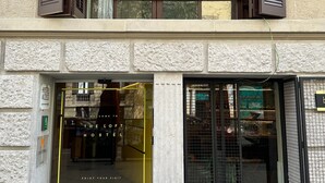 A hostel entrance with a glass door, a sign indicating hostel access, and a welcome sign. - The Loft House Barcelona (Barcelona)
