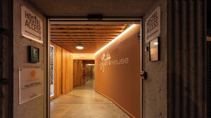 A hallway leading to a hostel with signs indicating hostel access and a sign for 'The Loft Hostel'. - The Loft House Barcelona (Barcelona)
