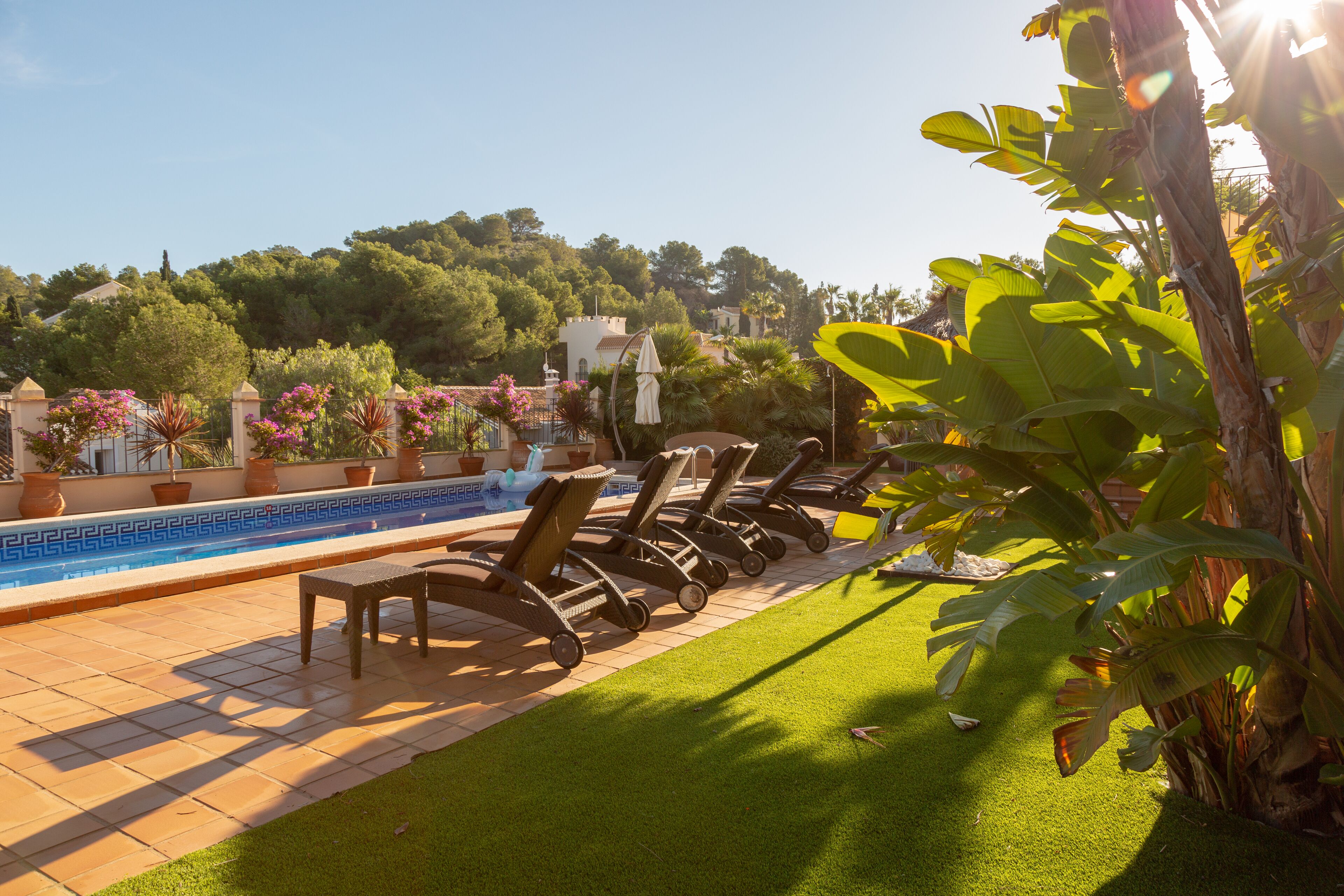 A poolside area with lounge chairs and a tiled pool.