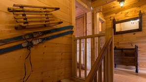 A wooden interior with a staircase, wooden walls, and a mirror. - Chalet 12-14 people  Le Grand Bornand - Chinaillon  (Le Grand-Bornand)