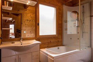 Bañera con ducha, secador de pelo, papel higiénico