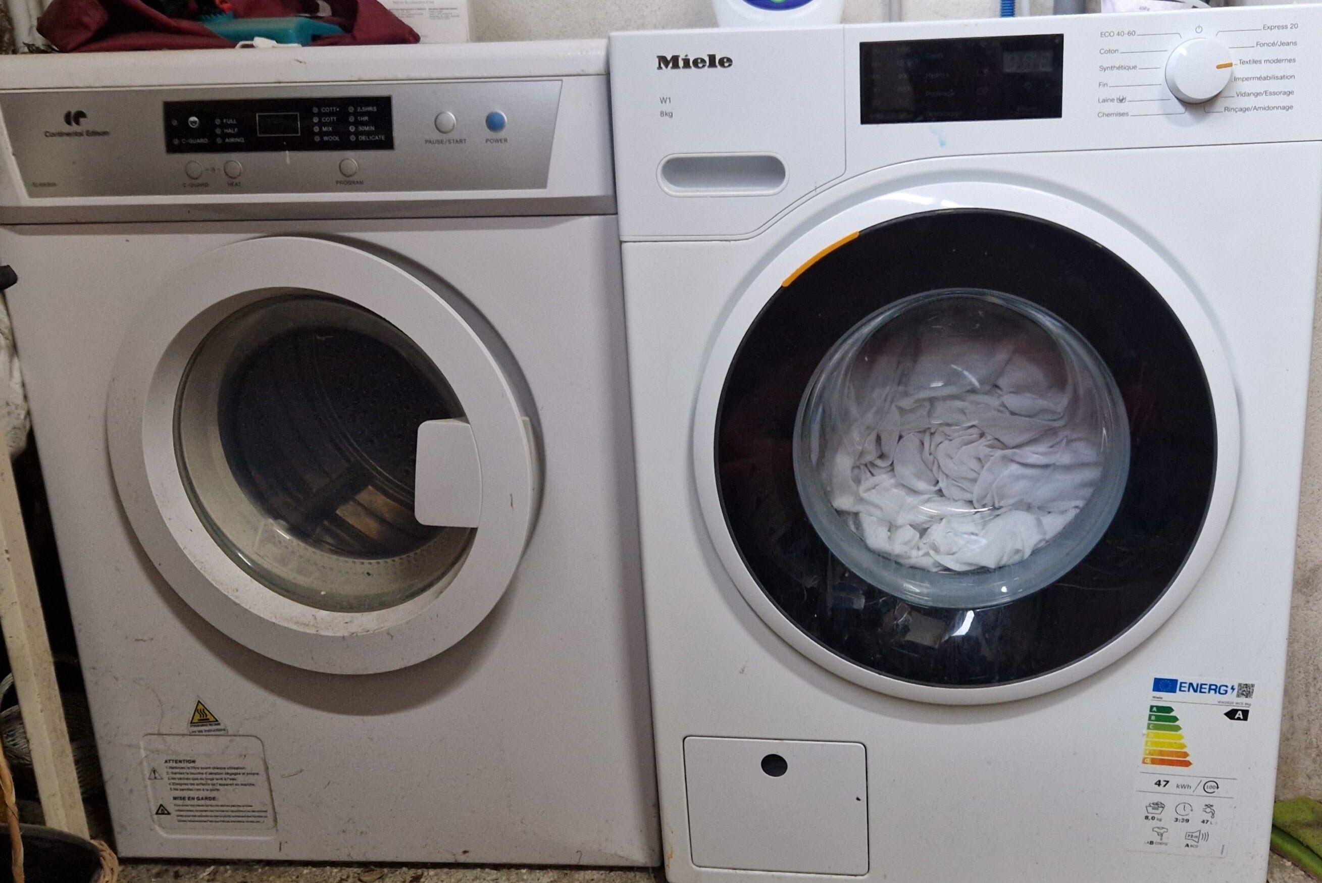 Eine Miele Waschmaschine mit Frontlader, einer Bedienblende und einer Tür.