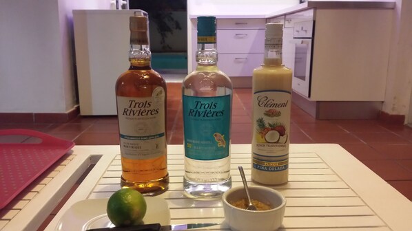 Three bottles of 'Trois Rivières' rum on a kitchen counter. - Gite canne à sucre Martinique, naturist residence (Sainte-luce)
