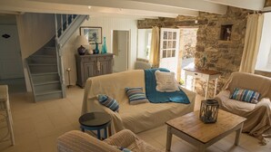 A cozy living room with a sofa, armchairs, a coffee table, and a staircase. - Old stone house between Crozon and Camaret (sea 200m) (Crozon)