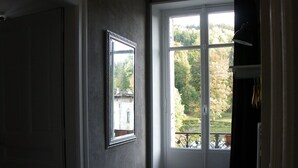 A bathroom with a window, a mirror, and a toilet. - Large apartment with view in 1900 villa (Plombières-les-Bains)