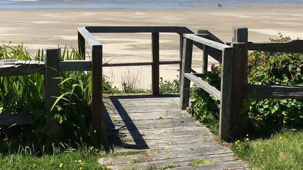 A wooden boardwalk leading to a beach with waves in the background. - Classic Honeymoon Beach Cottage. Private, Romantic, Oceanfront.  Pet friendly. (Waldport)