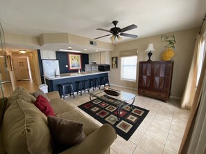 Relax in our spacious living room with a sofa sleeper couch, TV and balcony door