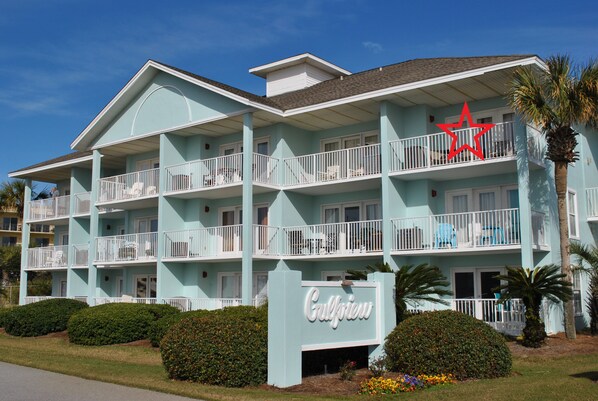 A multi-story hotel with balconies, a prominent star sign, and a sign reading "Gulfview".