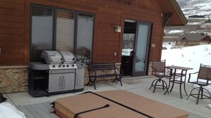 A patio with a grill, a bench, a table, and a mattress. - Ski, Mountains, Lake: 5 BR Vacation House at Wolf Creek Ut, Many Amenities (eden)