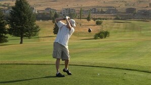A golfer on a golf course with a mountainous backdrop. - Ski, Mountains, Lake: 5 BR Vacation House at Wolf Creek Ut, Many Amenities (eden)