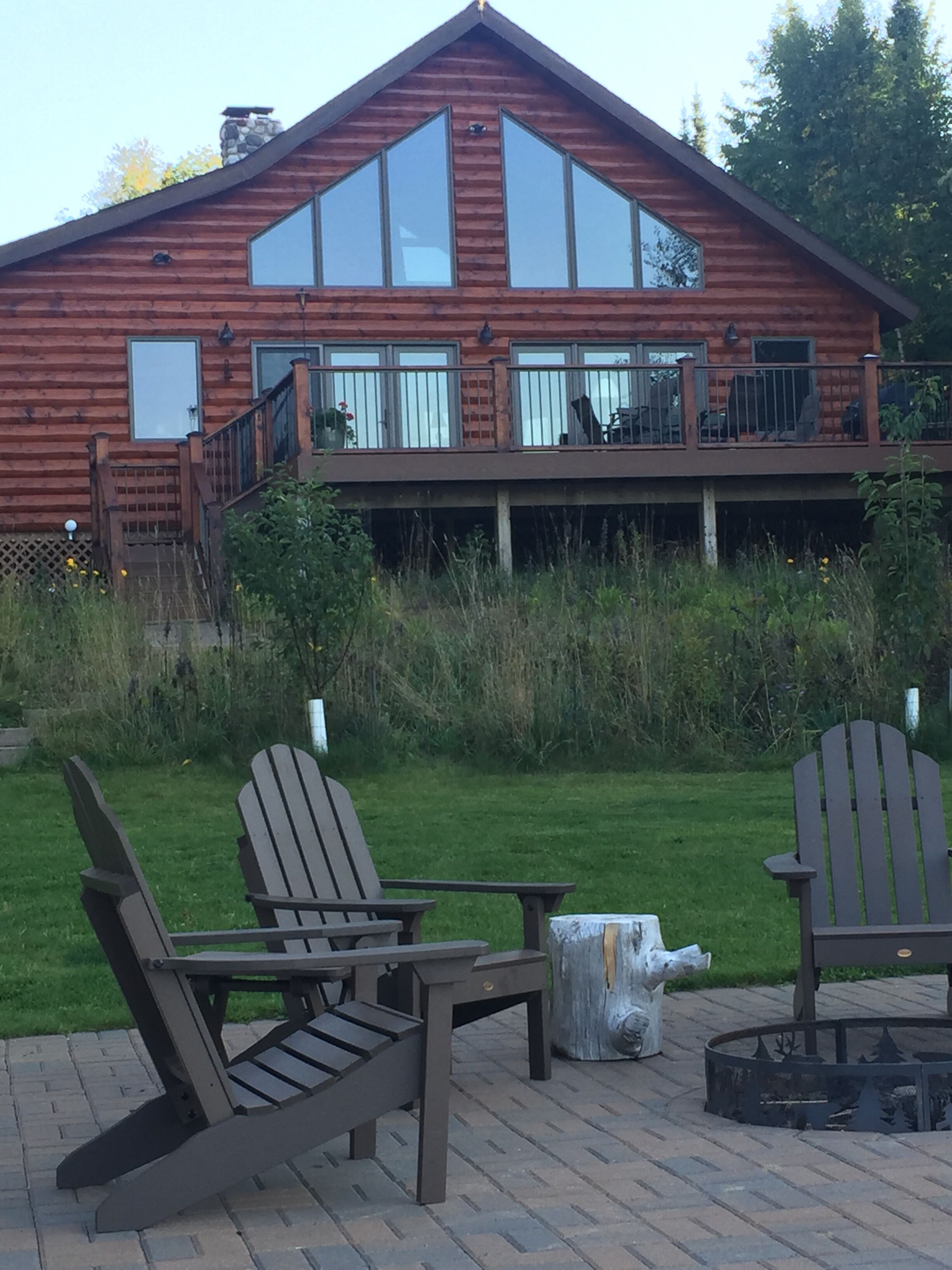 Lakeside of the cabin and patio with firepit