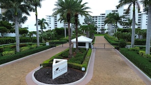 A sign for The Somerset at 780 South Collier Boulevard, surrounded by well-maintained landscaping and palm trees.