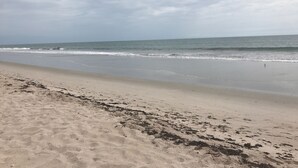 A beach with a sandy shore and waves approaching the beach. - SPACIOUS OCEAN FRONT PARADISE (Fort Pierce)