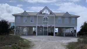 A two-story house with a porch and a covered walkway. - New Renovation 2024 Direct Gulf View! White Beach Dolphins 4 Bedrooms, 3.5 bath (Gulf Shores)