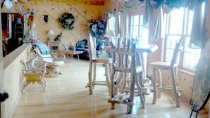 A room with a wooden floor, white furniture, and a large window. - Luxurious & Spacious!  A Great Place For Family, Friends, Reunions & Corporate! (Adams)