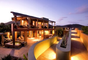 A modern resort with a pool, outdoor seating, and a well-lit patio area. - Private 2 Bedroom Complex Close To Beach (Cabo Pulmo)