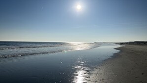 A beach with a clear sky and a sun reflecting on the water. - Ocean Boulevard Oasis - Beachfront, Spectacular Ocean View, Pool, Beach Access! (Isle of Palms)