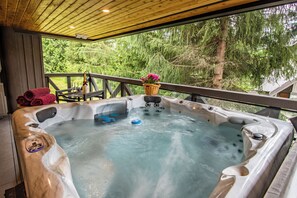 A hot tub with a wooden deck and a view of trees. - Pinnacle Ridge 23 - Ski in Ski out, Private Hot Tub, Gas Fireplace (Whistler)