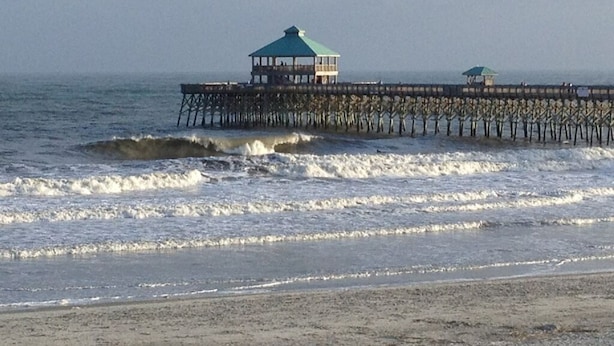A pier with two gazebos extending into the ocean. - Large Beach House for Bigger, Better Gatherings! (Folly Beach)