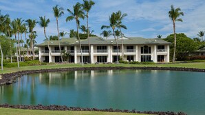 A large building with multiple balconies and a swimming pool in front. -  Access to Mauna Lani Spa/Tennis/Pickleball/Gym/Lap Pool included with booking (Waimea)
