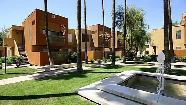 A modern building with a flat roof, rectangular windows, and a central courtyard with a water feature. - Old Town Scottsdale  (Scottsdale)