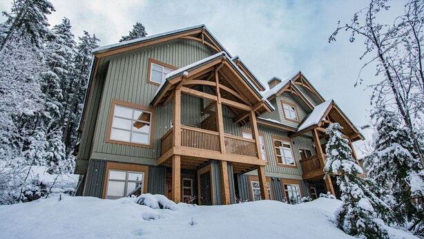 A large, multi-story wooden cabin surrounded by snow-covered trees. - Mountain Star 16 - Ski in Walk out, Private Hot Tub, Fireplace (Whistler)