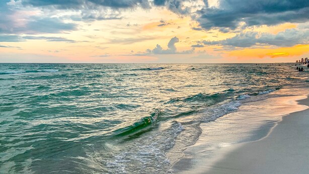 A beach with waves and a sunset. -  Boardwalk Beach Resort, Ocean/Beach front, Loaded w Amenities, Park your car!! (Panama City Beach)