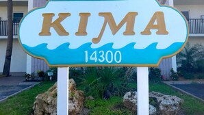A sign with the word "KIMA" and the number "14300" on it.
