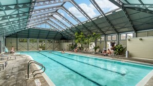 An indoor swimming pool with clear lanes, a roof structure, and potted plants. - Perfect Family Getaway | Bikes, Courtyard w/Fire Feature, Walk to Pool & Fitness (Rosemary Beach)