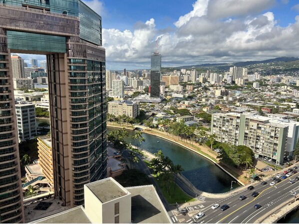 A high-rise building with a river running through the city.