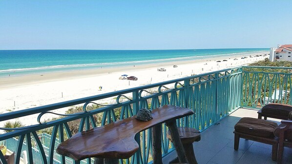 Outdoor dining - Stylish beach front condo with spectacular view! (New Smyrna Beach)