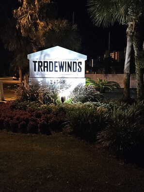 Welcome to Tradewinds 24568, where lush greenery and palm trees surround the property.