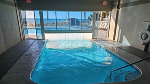 A pool area with a view of the ocean, a lifeguard chair, and a no diving sign. - Beautiful Ocean Front Condo in Orange Beach....Affordable Prices (Orange Beach)