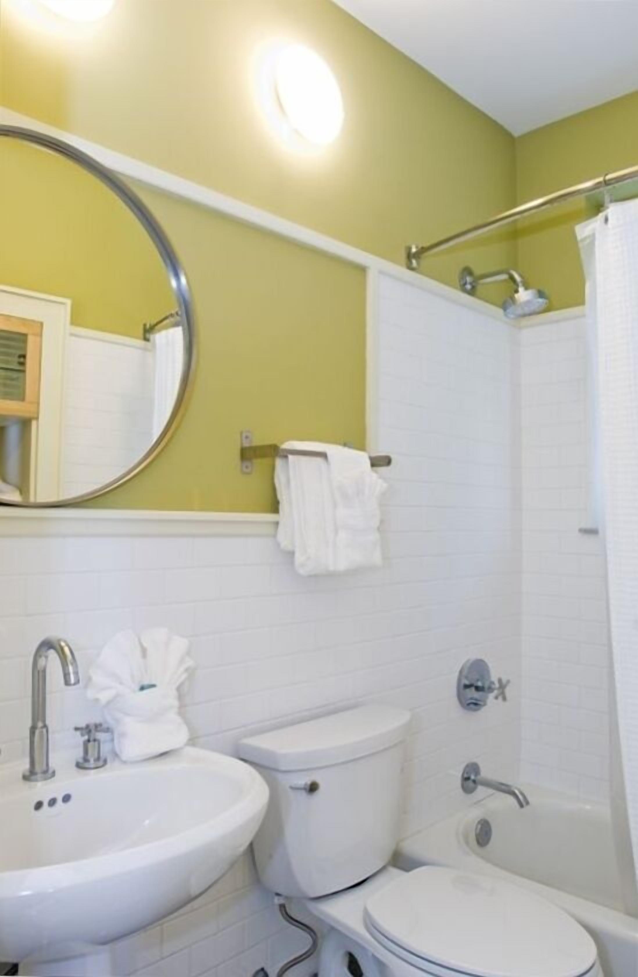 A bathroom with a sink, toilet, and bathtub.