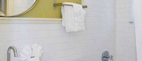 A bathroom with a sink, toilet, and bathtub.