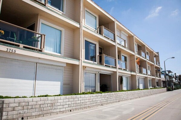 A multi-story residential building with a brick facade, numbered 3755.