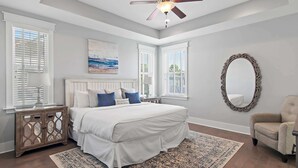 A bedroom with a large bed, a ceiling fan, and a large mirror. - 6-Seater Golf Cart & 6 Bikes! Newly Furnished! 2 Resort Pools! Sunset at Seagrove on 30A (Santa Rosa Beach)