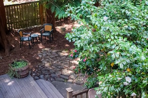 Relax in a serene outdoor space surrounded by lush greenery and a tranquil atmosphere.