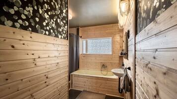 Bathtub, eco-friendly toiletries, hair dryer, towels