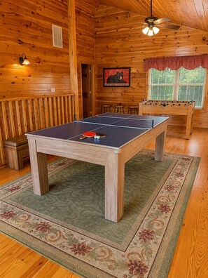 A wooden room with a ping pong table, a foosball table, and a ceiling fan. - 6 BD 6 BATH ALL Ensuite cabin. Come make memories for a lifetime! (Sevierville)